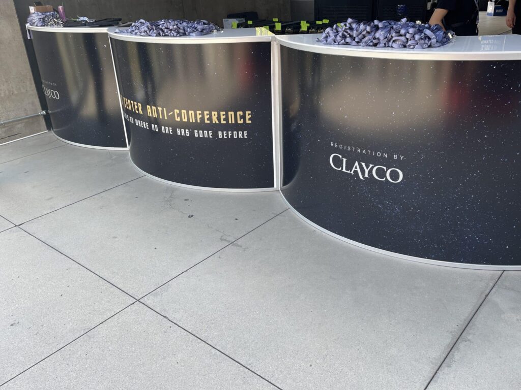 Restaurant Show booth furniture: a curved event bar with a custom printed brand wrap
