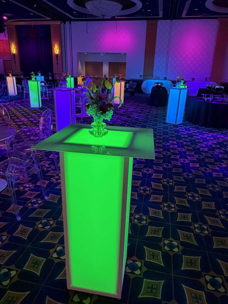 Illuminated High Boy cocktail tables glowing green at a Chicago hotel reception